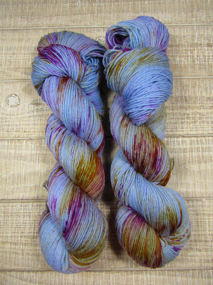 Hand-Dyed Yarn BillieJean is blue yarn with areas of monarch orange and berry crush.