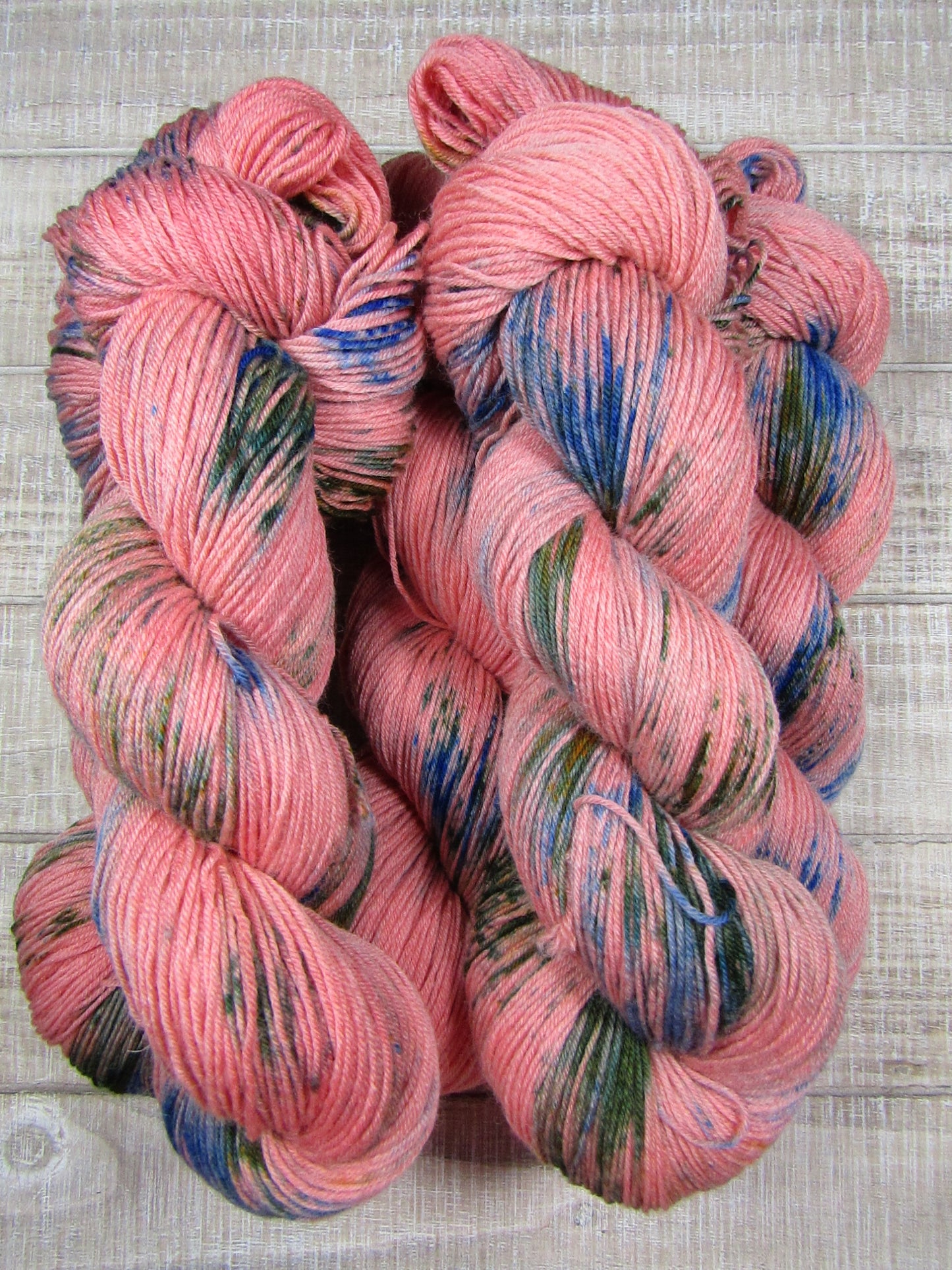Hand-Dyed Yarn Camille is russet yarn with areas of brilliant blue and avocado green.