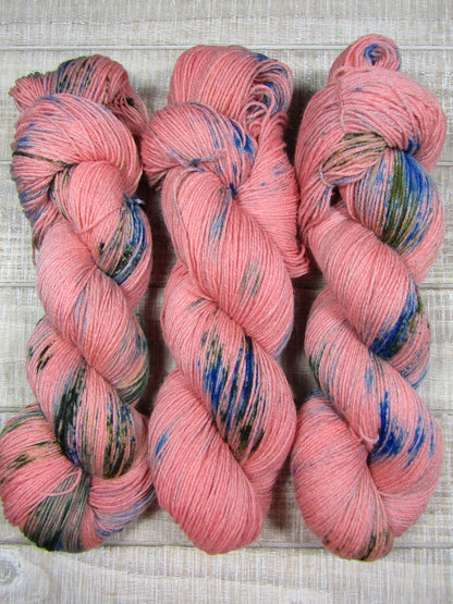 Hand-Dyed Yarn Camille is russet yarn with areas of brilliant blue and avocado green.