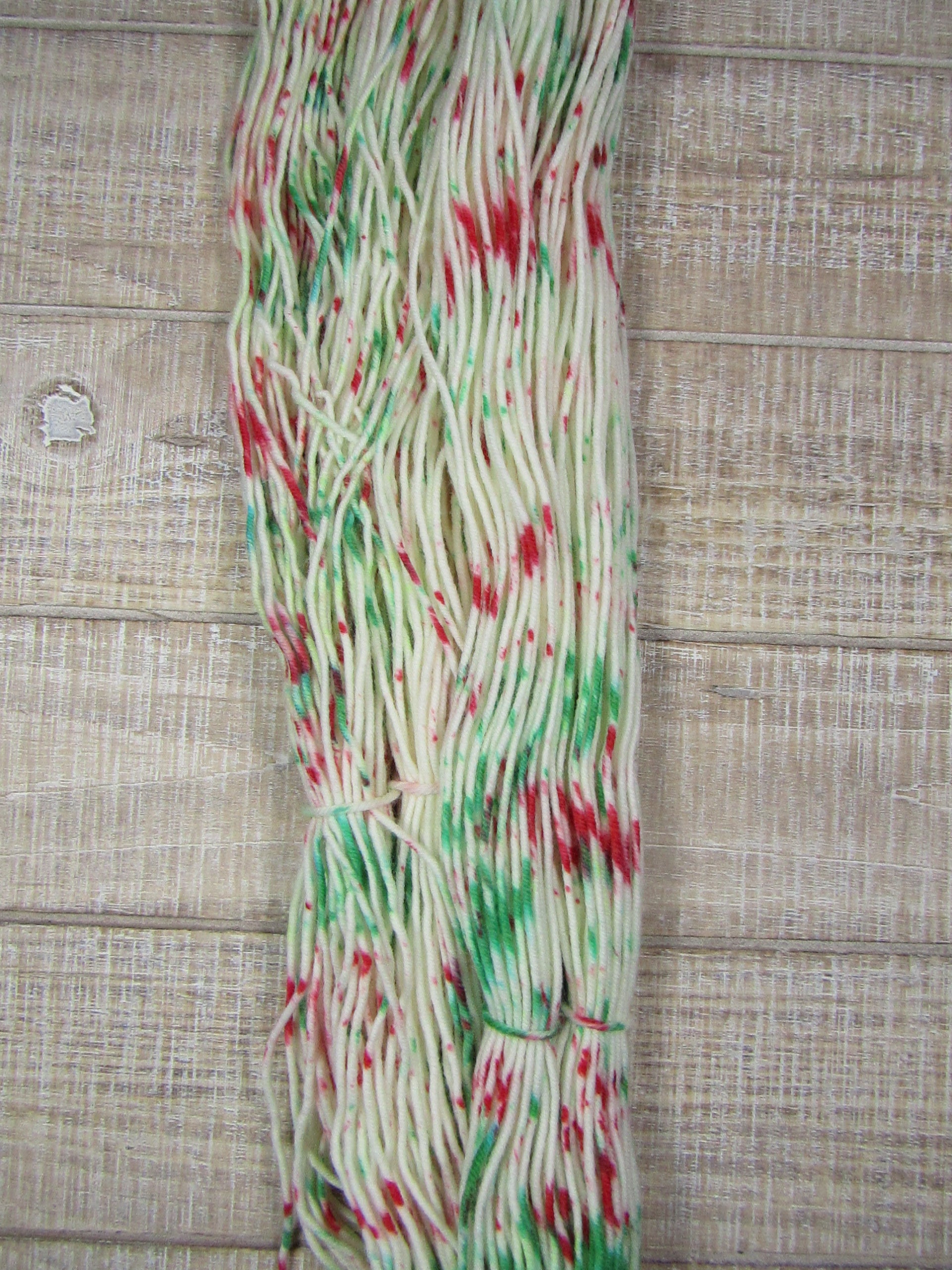 Hand-dyed yarn - Candy Cane Merino/Cashstyle nylon worsted weight yarn with green and red speckles.