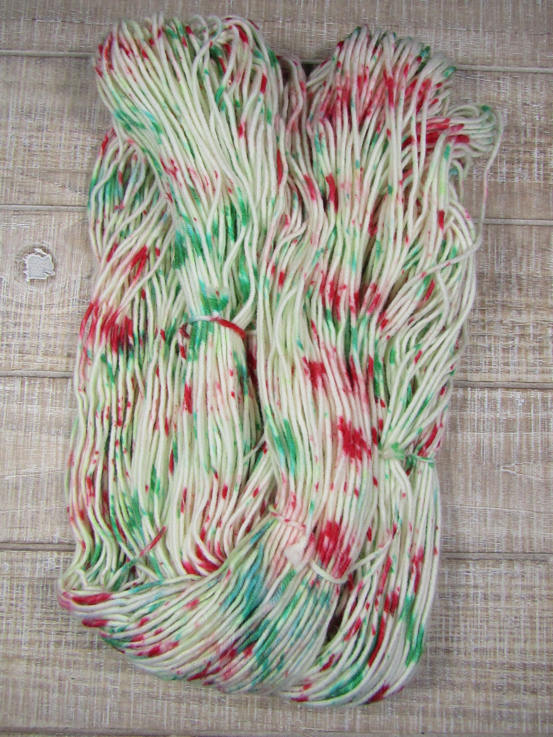 Hand-dyed yarn - Candy Cane Merino/Cashstyle nylon worsted weight yarn with green and red speckles.
