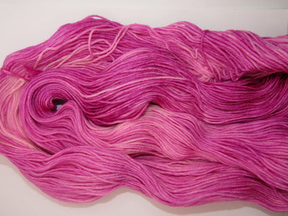 Hand-Dyed Yarn Rose Single Skein of yarn in shades of berry crush, a bright pink.