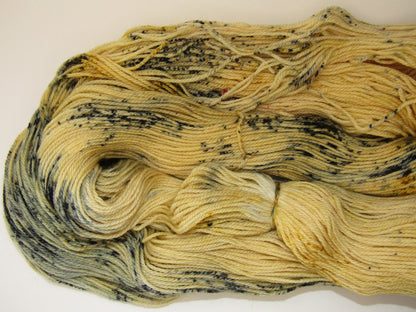 Hand-Dyed Yarn Sawyer Single Skein of yarn in a main color of golden straw with speckles of blue, red and mustard.