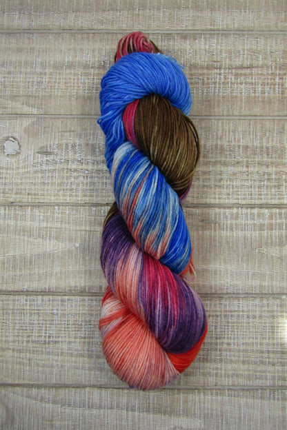Hand-Dyed Yarn Bart is a mix of purple, chestnut, blue, pink and salmon colors.