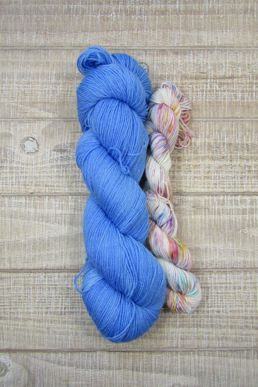 Hand-Dyed Yarn Set Bold Blues Sock a full-sized skein of yarn in a bold blue colorway paired with a speckled mini skein.