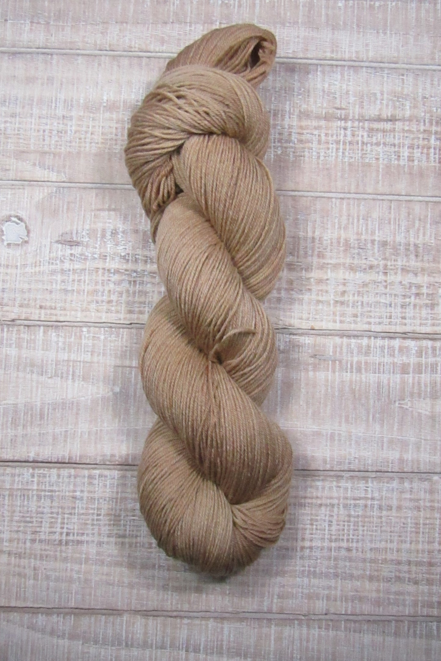 Hand-Dyed Yarn Buddy Superwash Merino/Nylon fingering weight yarn in a solid shade of brown.