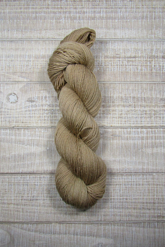 Hand-Dyed Yarn Buddy Superwash Merino/Nylon fingering weight yarn in a solid shade of brown.