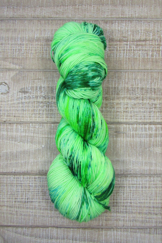 Hand-Dyed Yarn in a color of kelly green with kelly green and emerald green speckles.