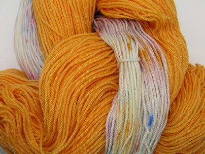 Hand-Dyed Yarn Set Light Monarch A skein of yarn in light Monarch orange with a speckled mini skein.