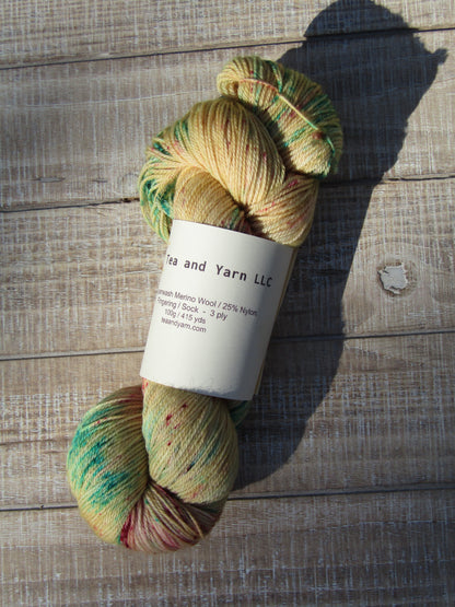 Hand-Dyed Yarn Harry is a color of golden straw with speckles of red and bright aqua.