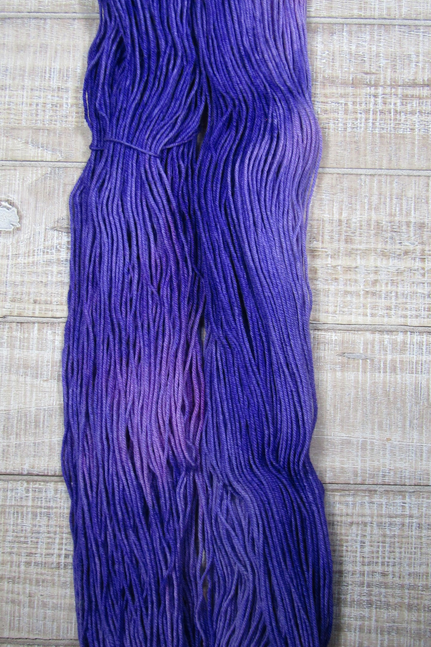 Hand-Dyed Yarn Superwash Merino/Nylon Fingering Weight Pansy shades of purple.