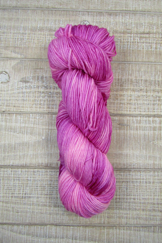 Hand-Dyed Yarn Rose Single Skein of yarn in shades of berry crush, a bright pink.