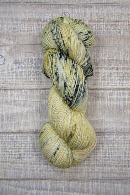 Hand-Dyed Yarn Sawyer is a main color of golden straw with speckles of blue, red and mustard.