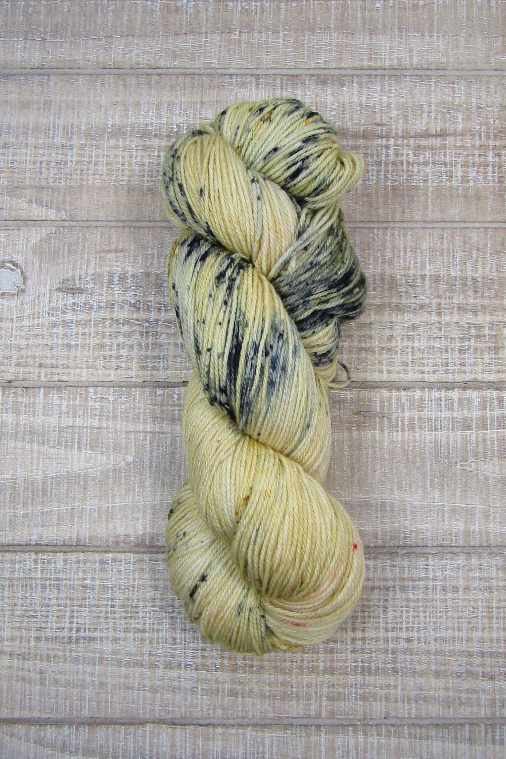 Hand-Dyed Yarn Sawyer is a main color of golden straw with speckles of blue, red and mustard.